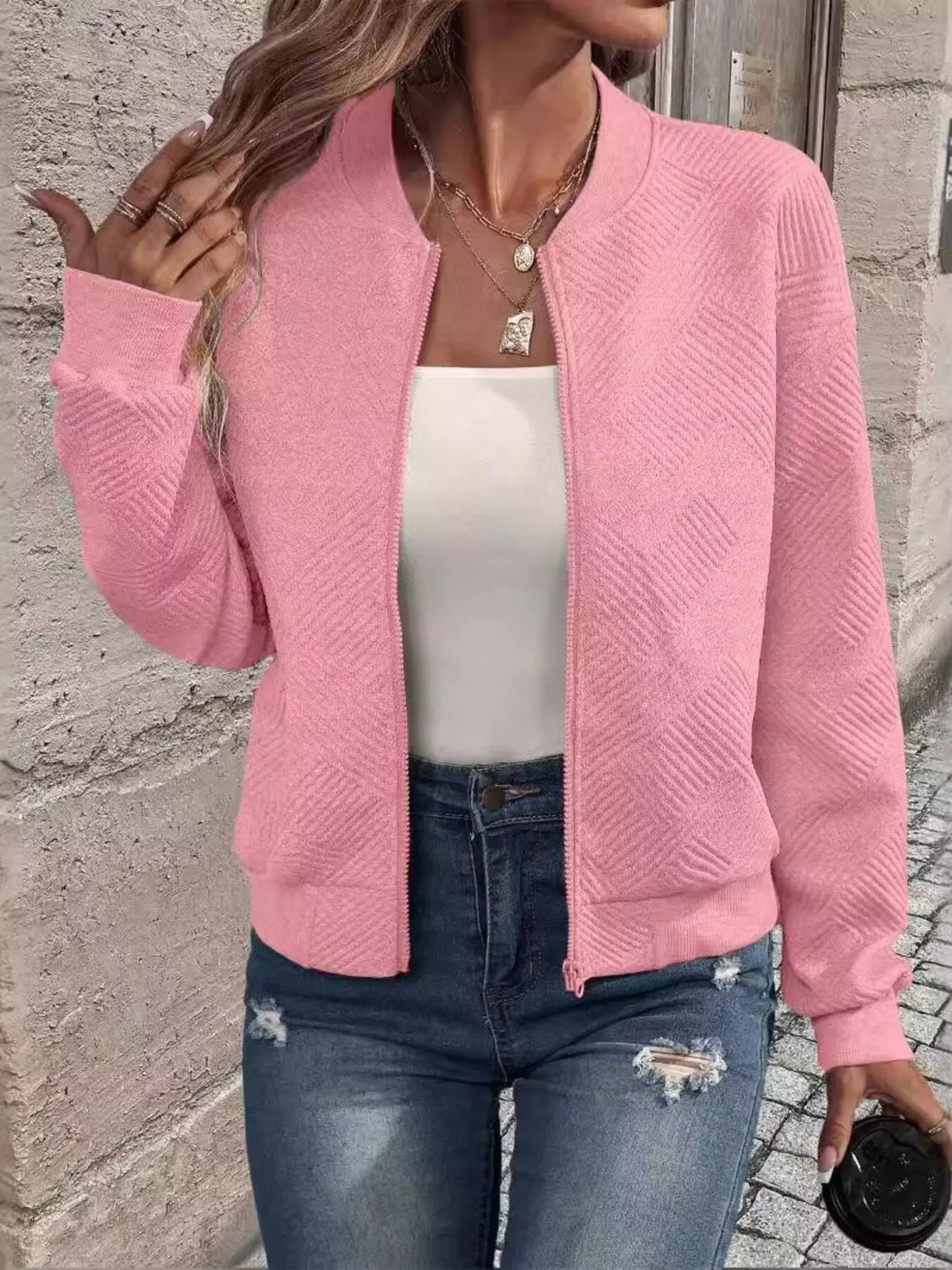 Pink textured knit zip-up jacket with front pockets and full-length zipper