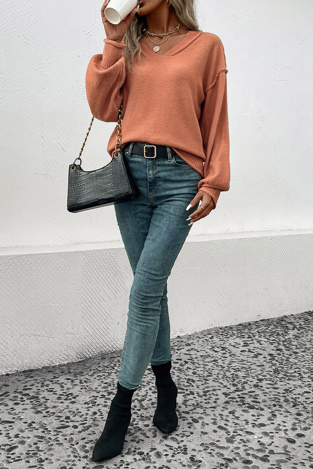 Pumpkin orange long-sleeve V-neck sweater with ribbed neckline and cuffs