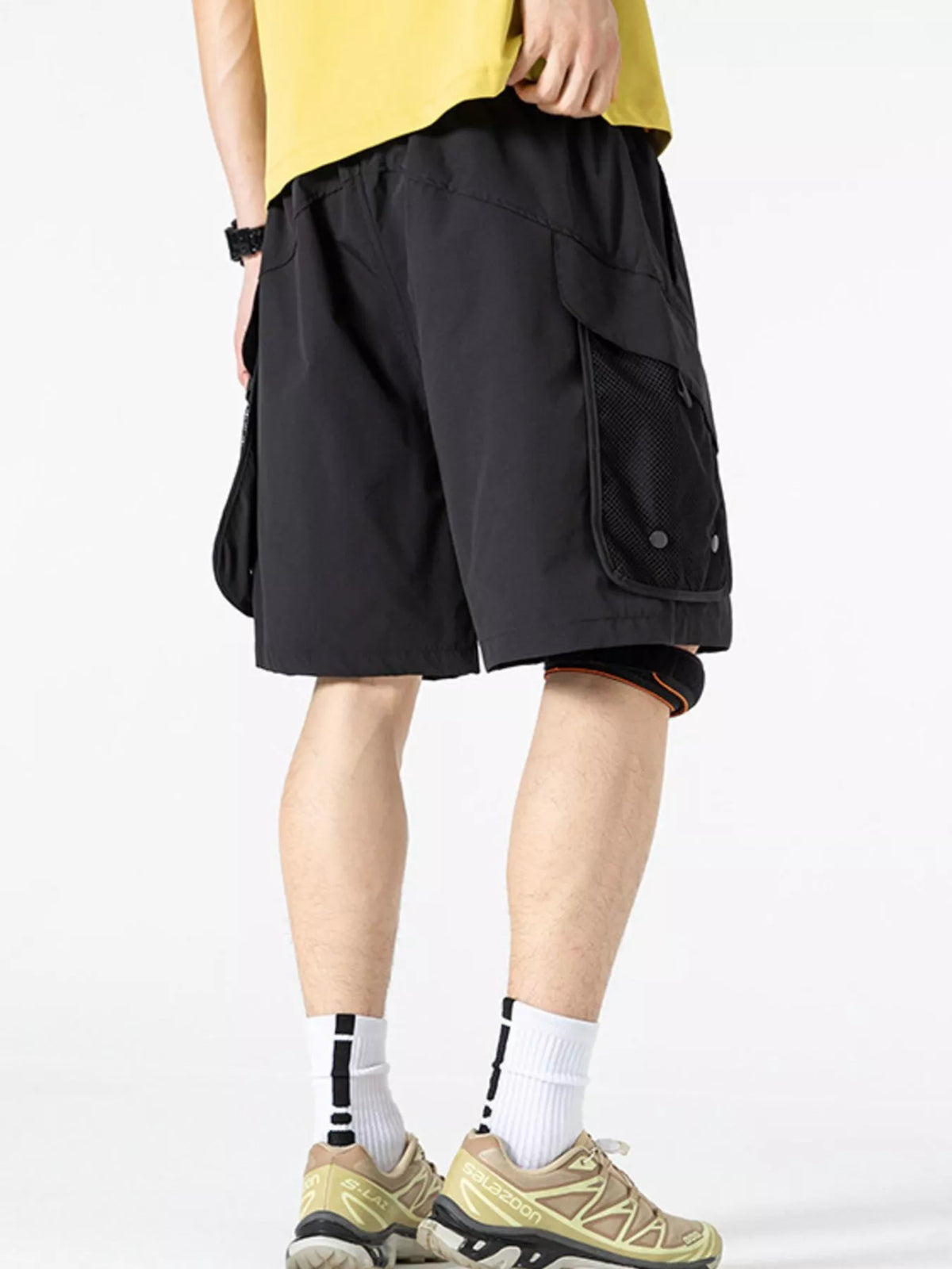 Men's lightweight cargo shorts in dark color with side cargo pocket and drawcord hem