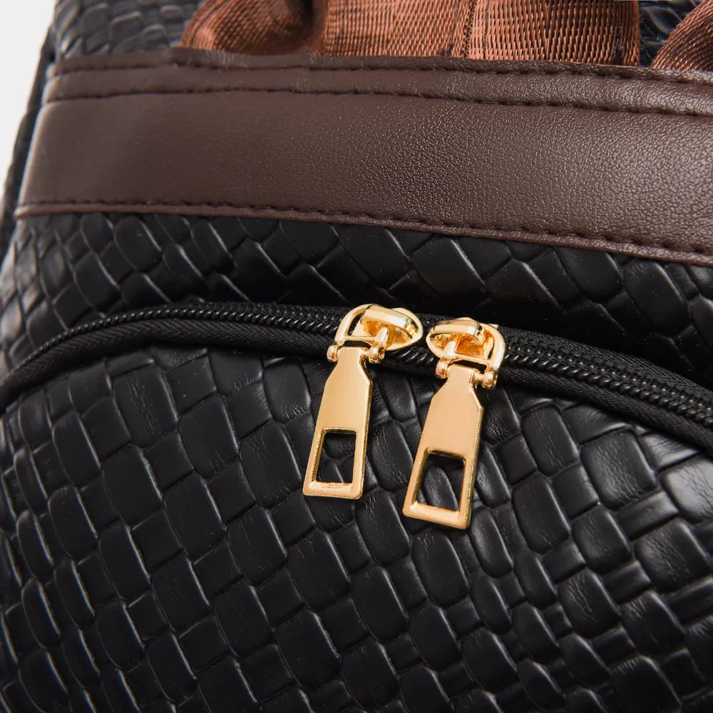 Vegan leather backpack bag zipper detail with gold hardware on black textured fabric