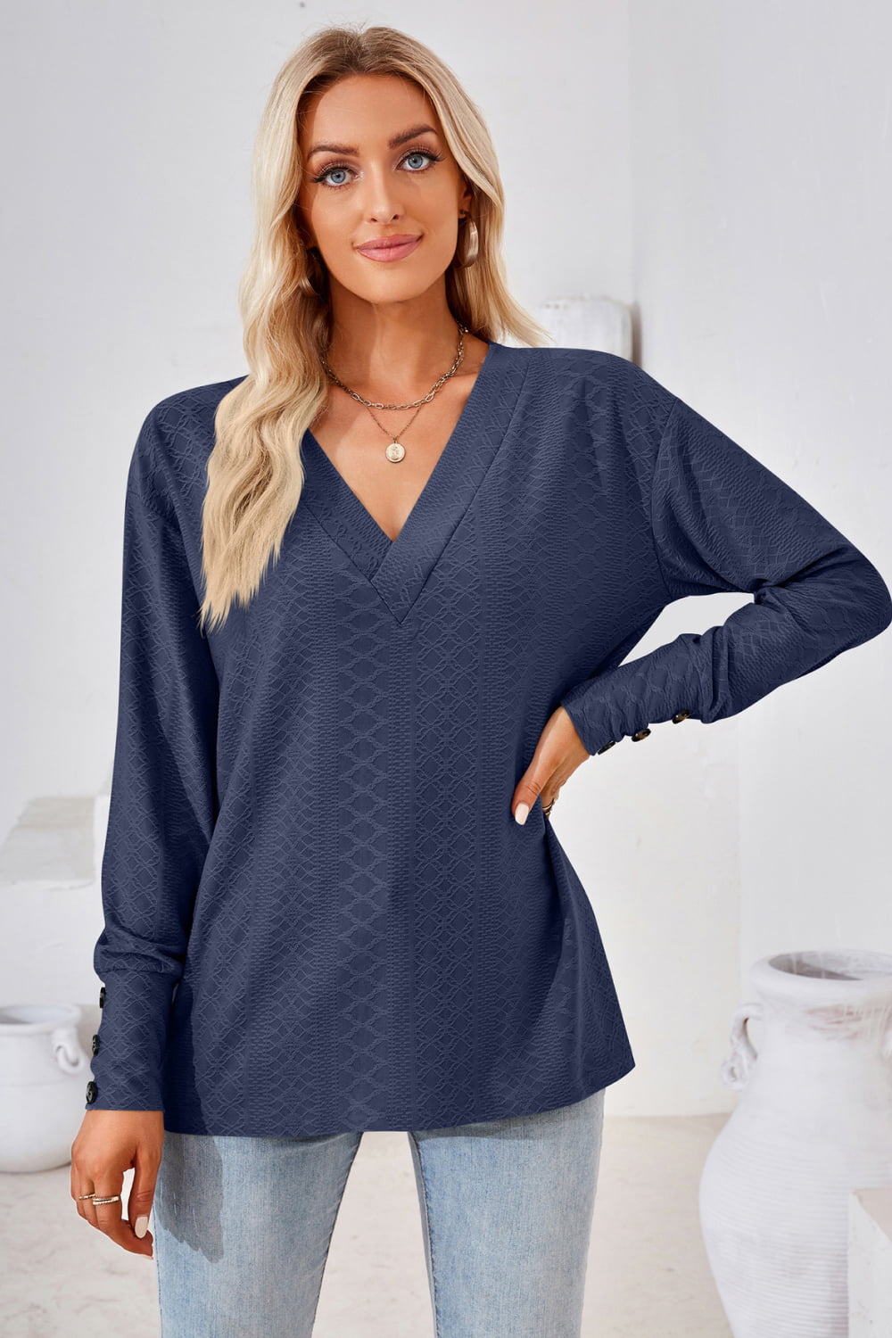 Dark blue V-neck long-sleeve blouse with textured diamond pattern and long sleeves