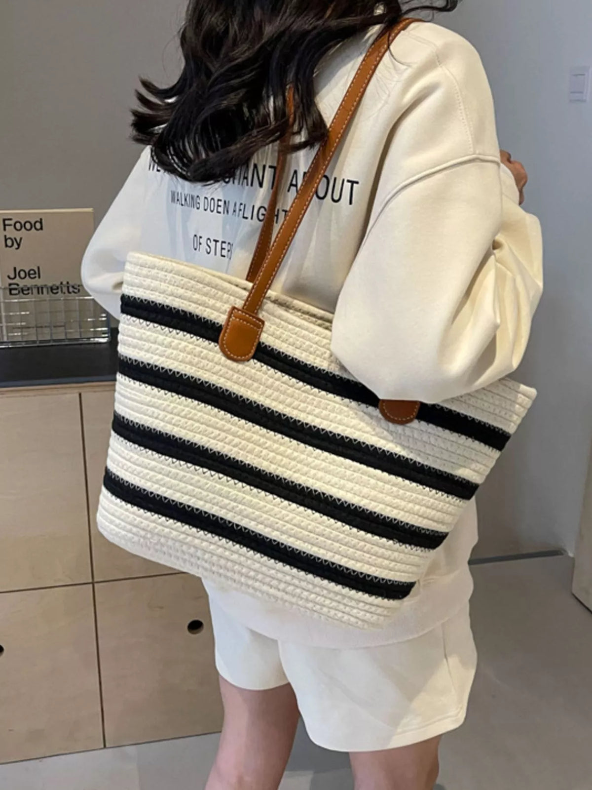 Striped straw tote bag, white weave with navy stripes and two brown top handles
