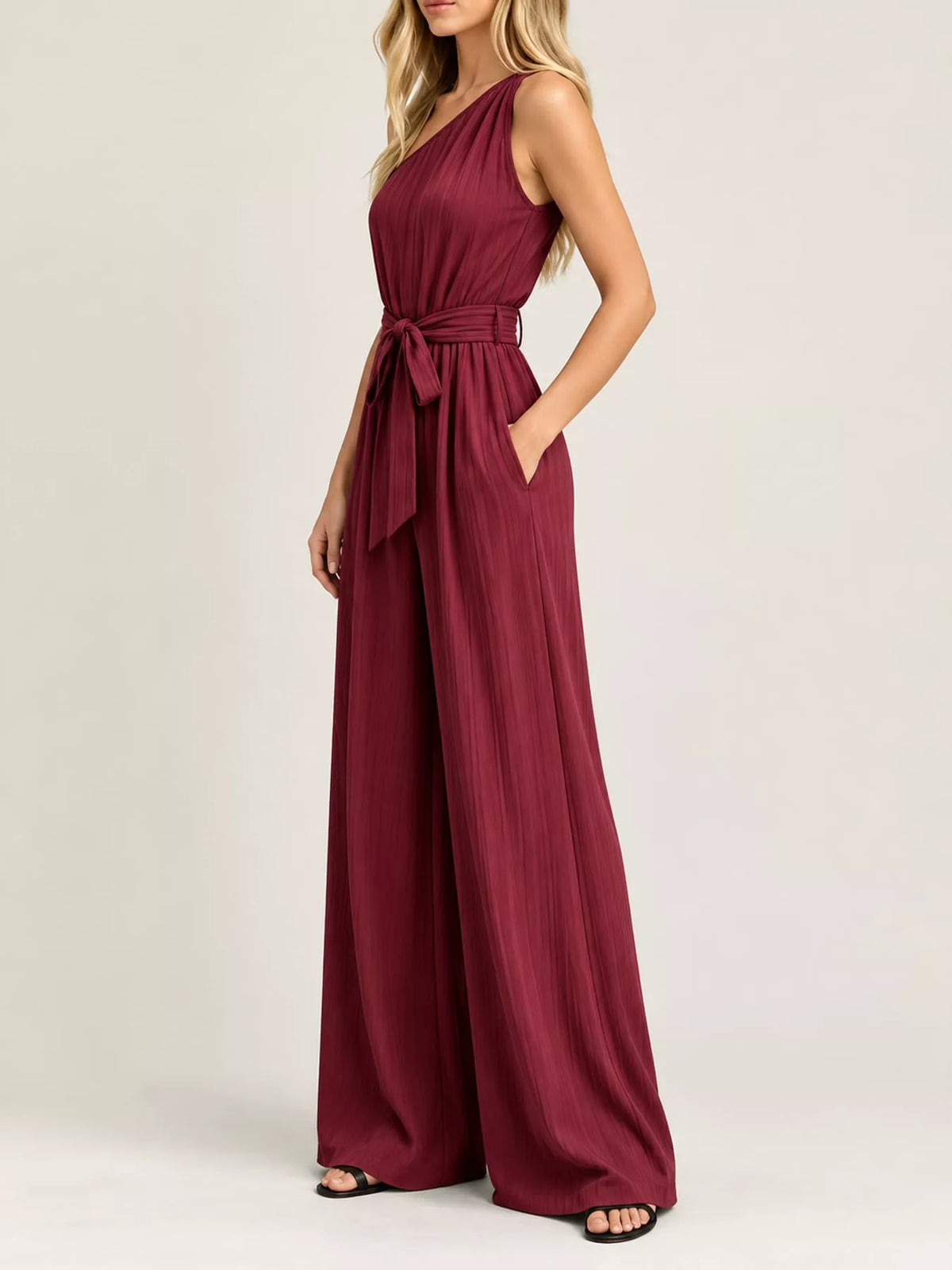 Burgundy one-shoulder wide-leg jumpsuit with draped waist ribbon tie