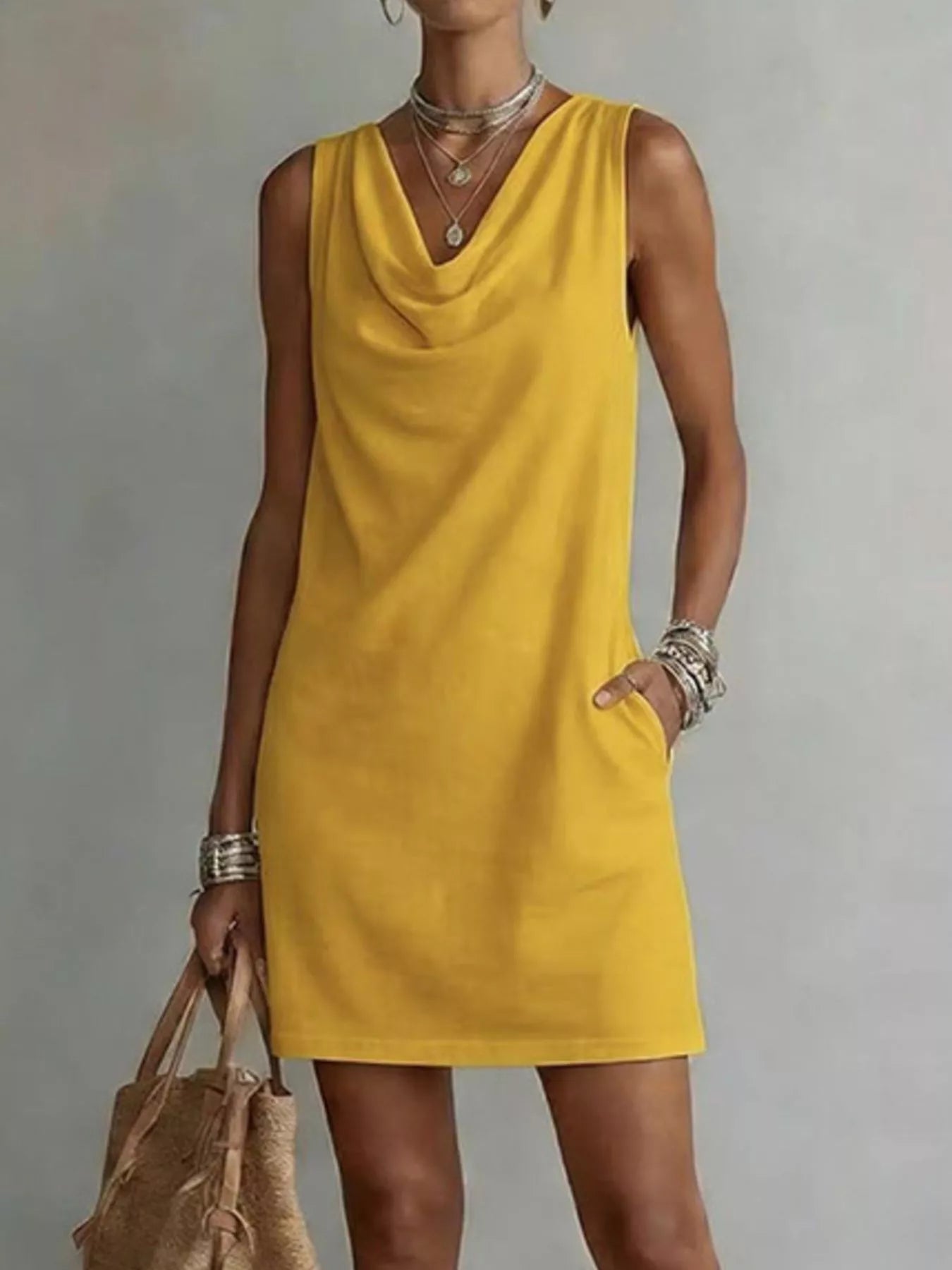 Yellow sleeveless cowl-neck mini dress with draped neckline and straight hemline.