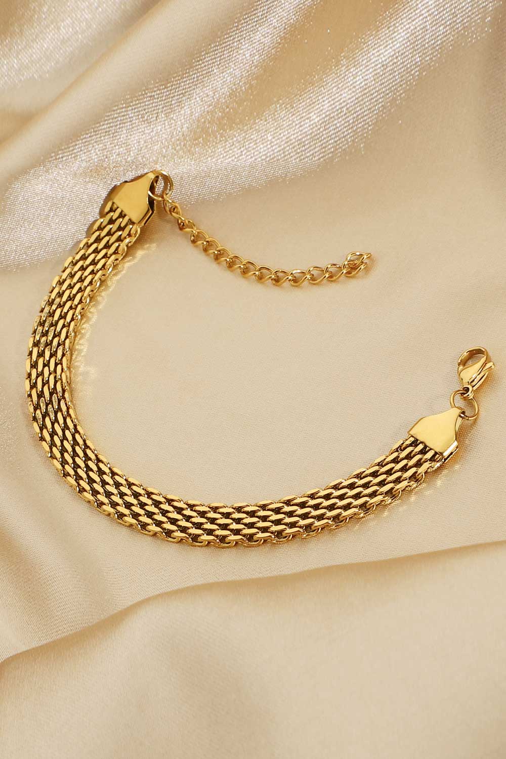Gold-plated wide chain bracelet close-up of woven chain and clasp hardware