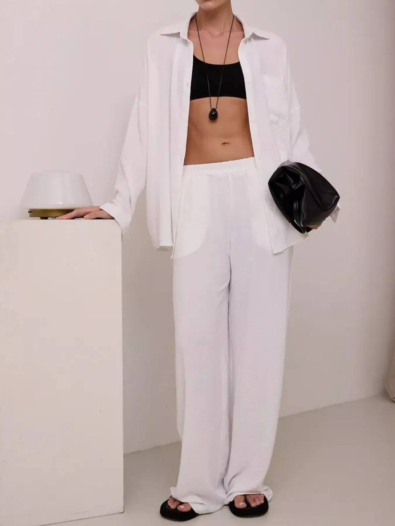 White relaxed shirt and wide-leg pants set, long-sleeve shirt worn over wide-leg pants