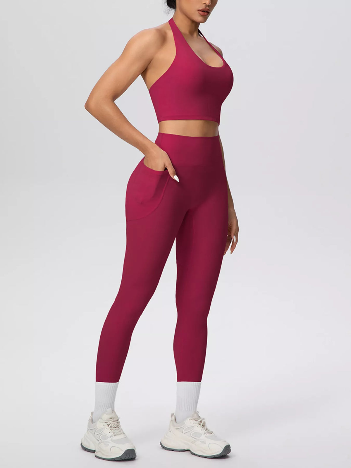 Burgundy halter crop top and high-waist pocketed leggings, side view, full-length