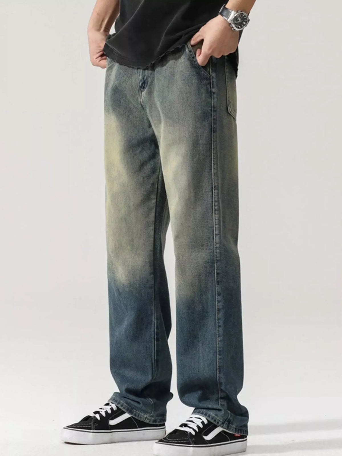 Men's washed teal denim jeans with wide legs and visible rear pocket