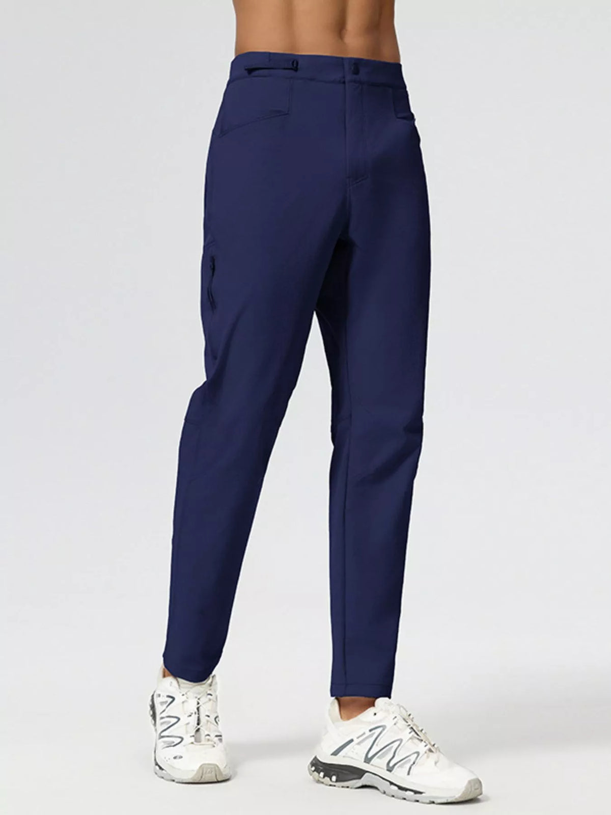 Men's slim-fit stretch casual pants in navy blue, side view with button closure