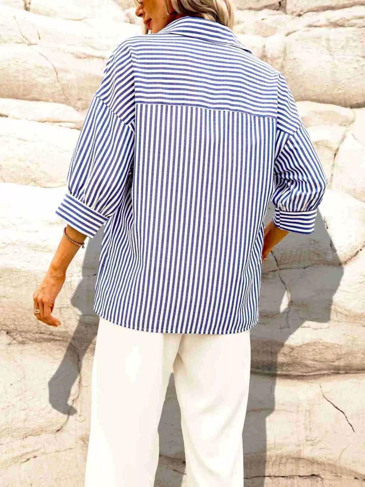 Blue and white striped button-down shirt with long sleeves, back view