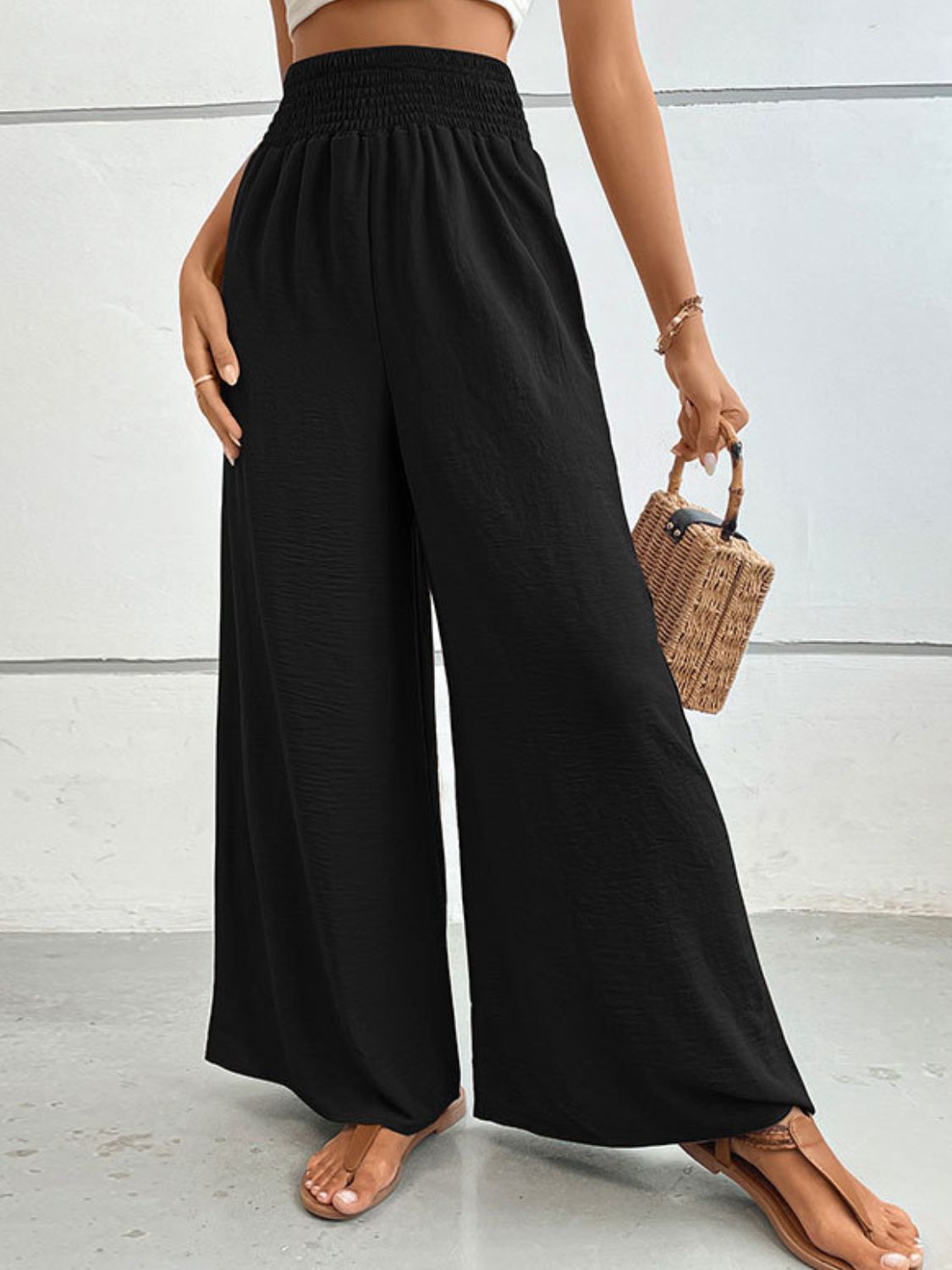 Black wide-leg long pants with smocked elastic waist and loose, full-length legs