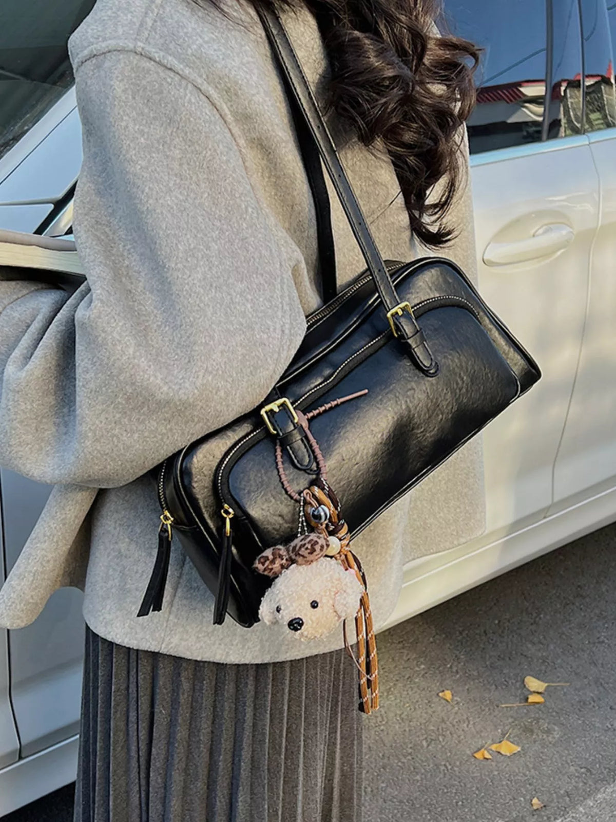 Medium vegan leather shoulder bag, black, front buckles, gold accents, hanging charm
