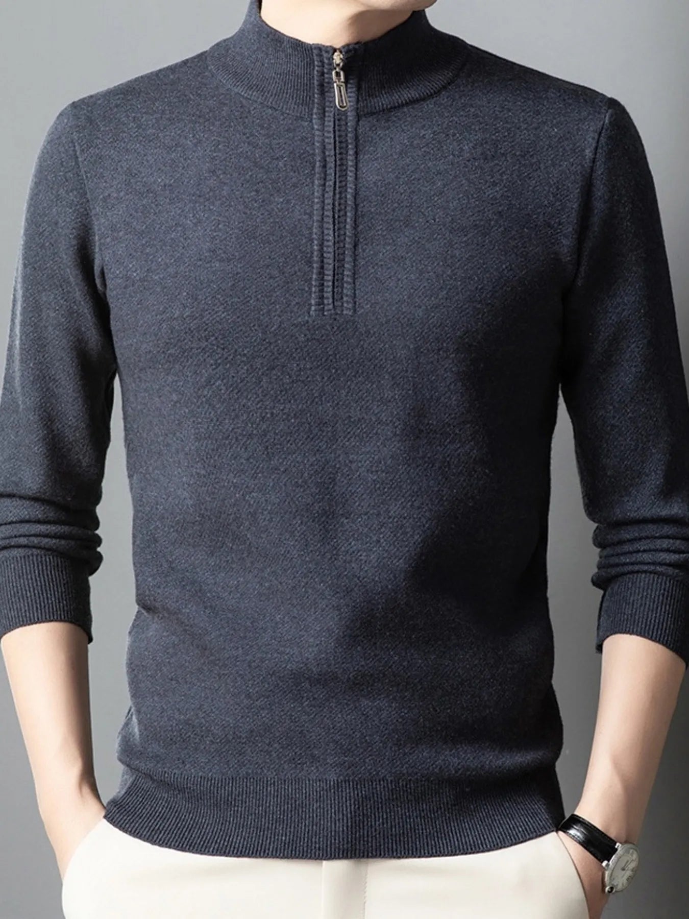 Dark gray quarter-zip long-sleeve sweater with ribbed hem, cuffs, and zip placket