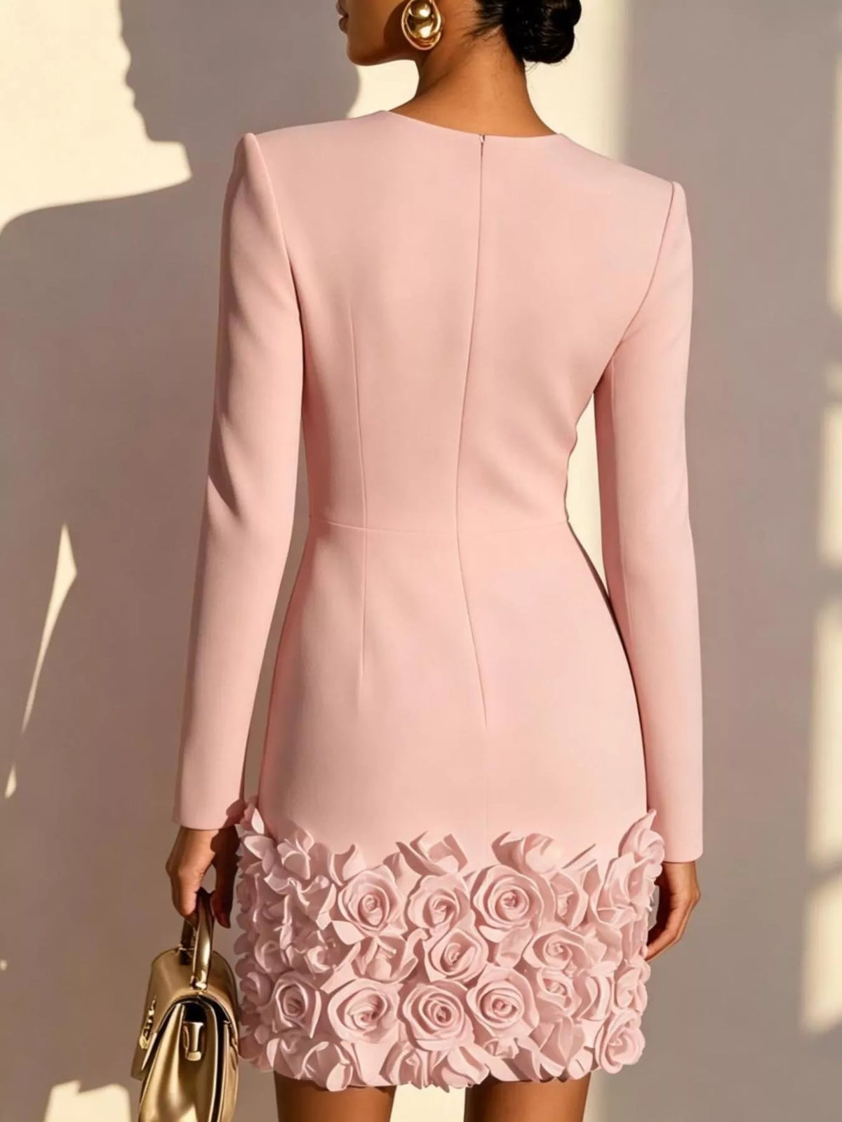 Back view pale blush V-neck long sleeve mini dress with 3D rose floral hem.