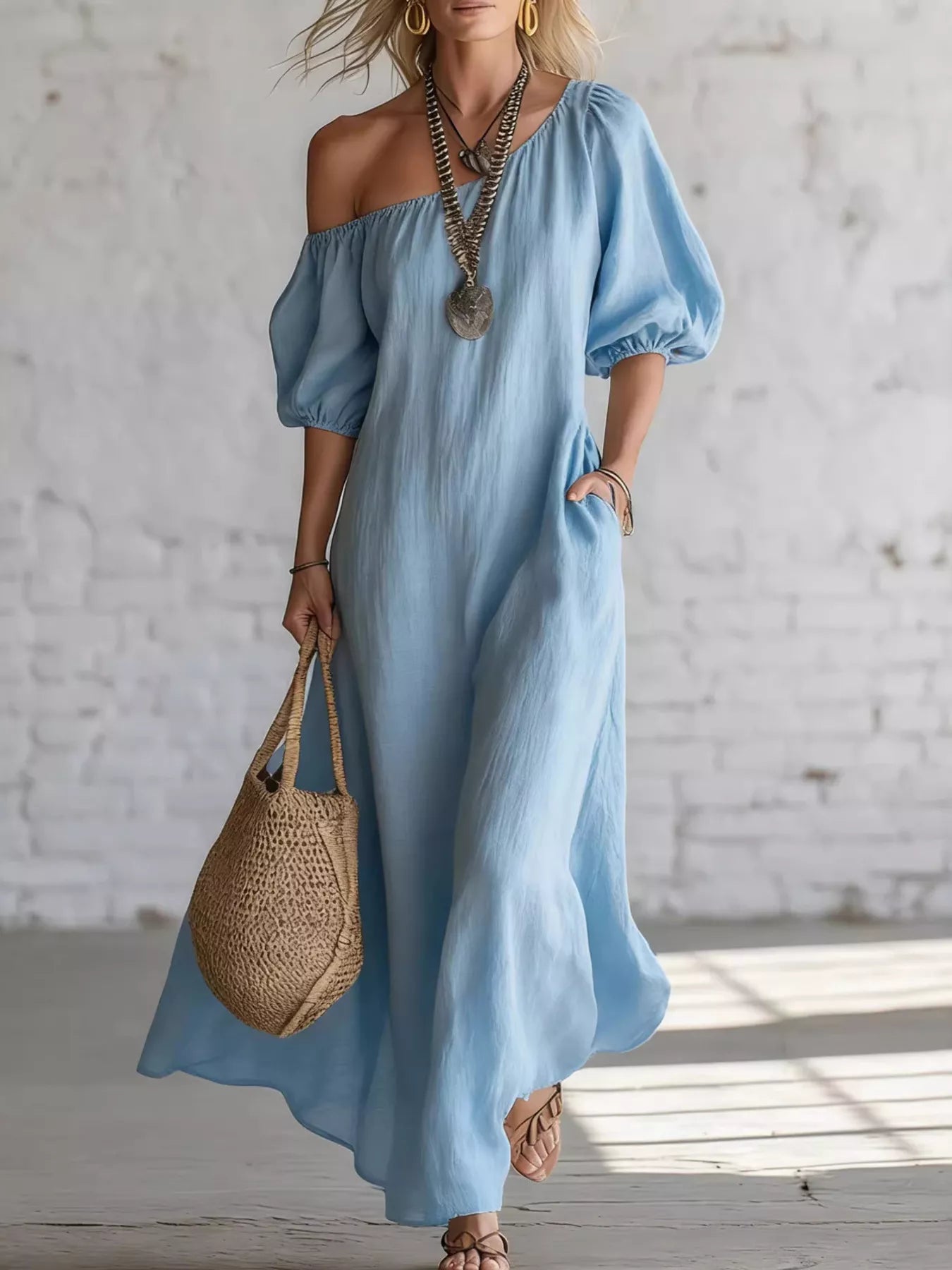 Sky blue one-shoulder maxi dress with puff sleeves and flowing draped skirt