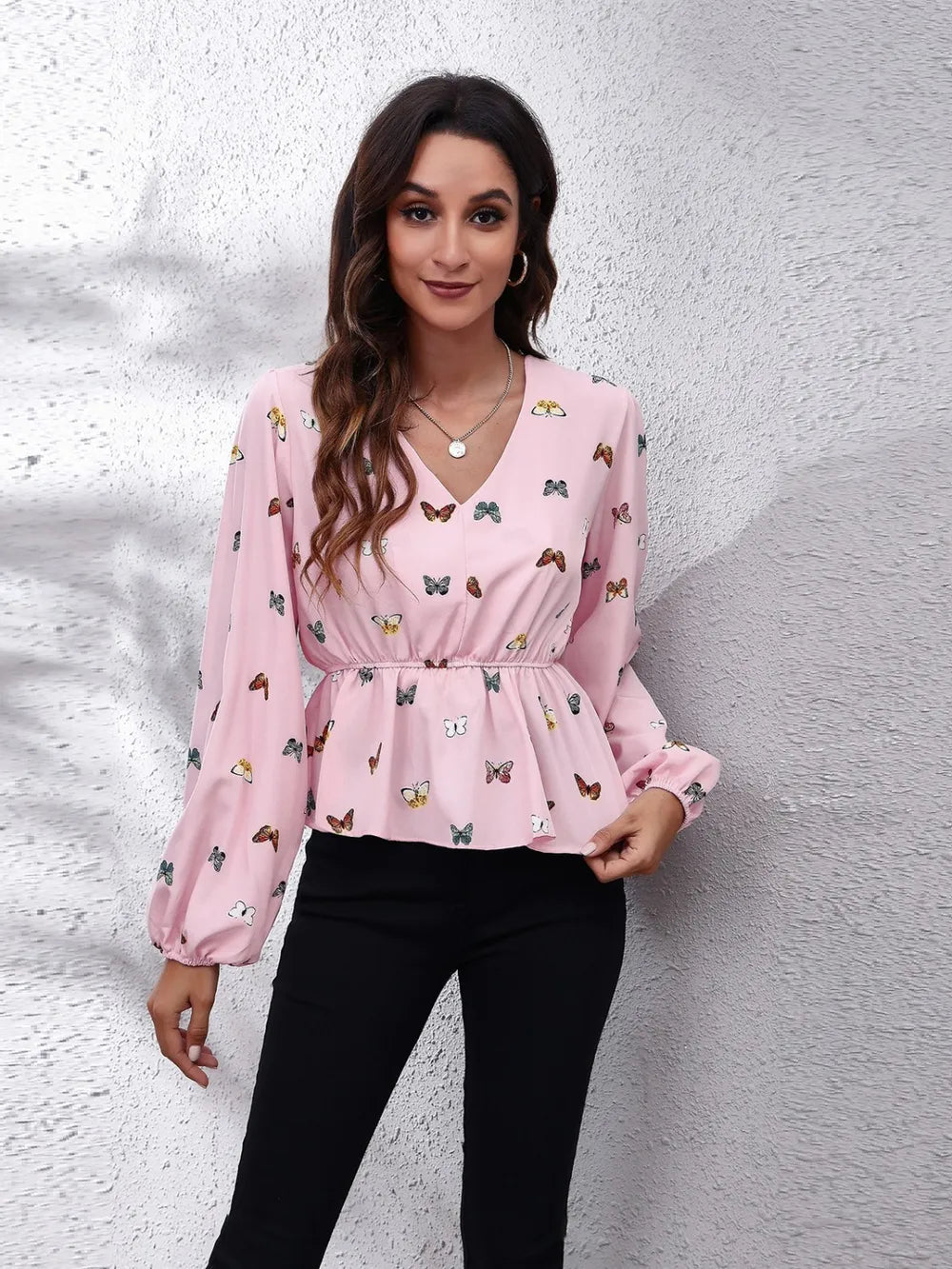 Blush pink butterfly print V-neck peplum blouse with balloon sleeves