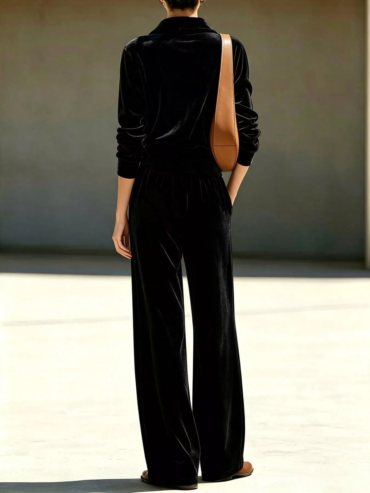 Black quarter-zip top and wide-leg pants from back view