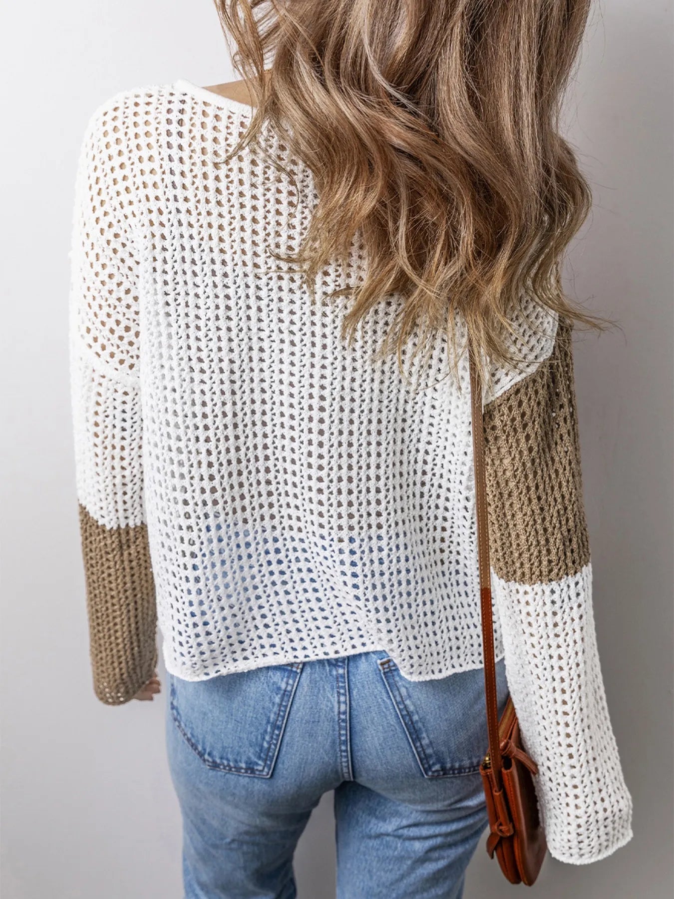 Openwork V-neck sweater with tassel details and white knit, beige sleeve panels