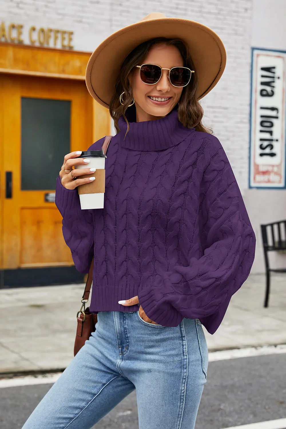 Plum cable-knit turtleneck sweater with long sleeves and textured cable pattern
