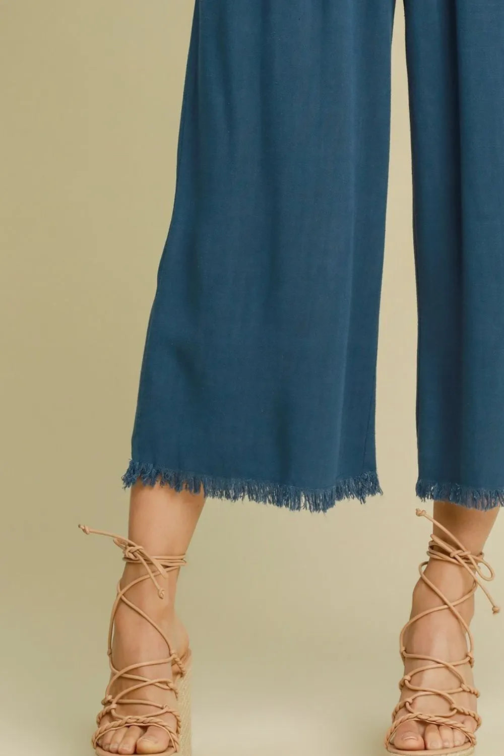 Peacock blue wide-leg pants with elastic waistband and frayed ankle hem