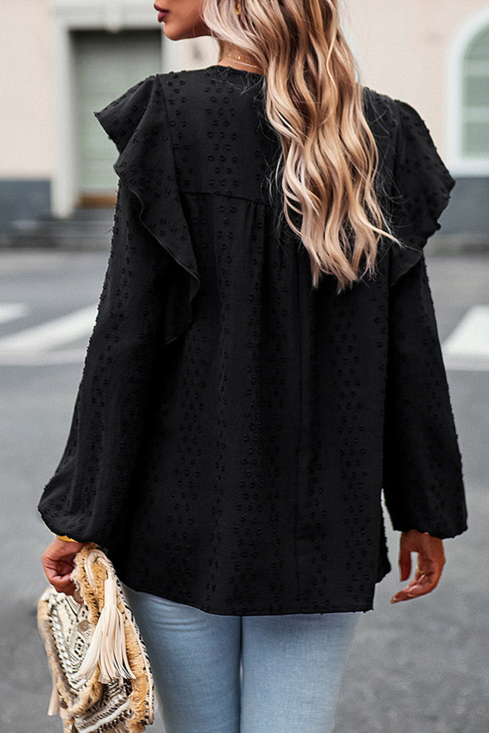 Ruffled round-neck blouse in black with long puff sleeves and allover tiny dot pattern