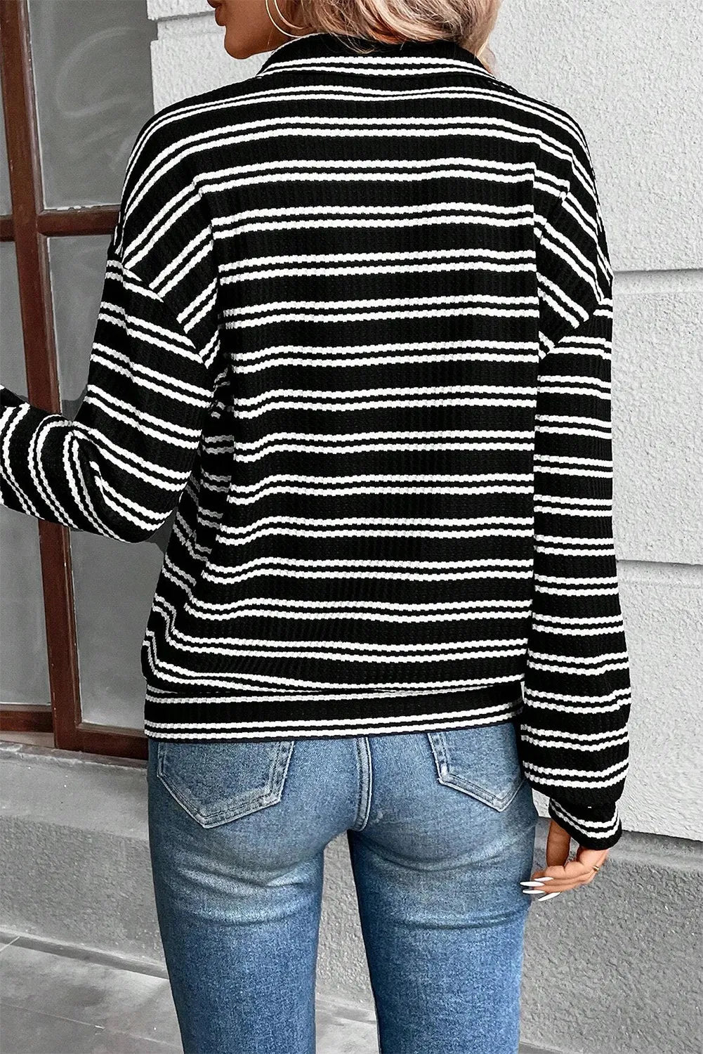 Black-and-white striped half-zip long sleeve top, back view