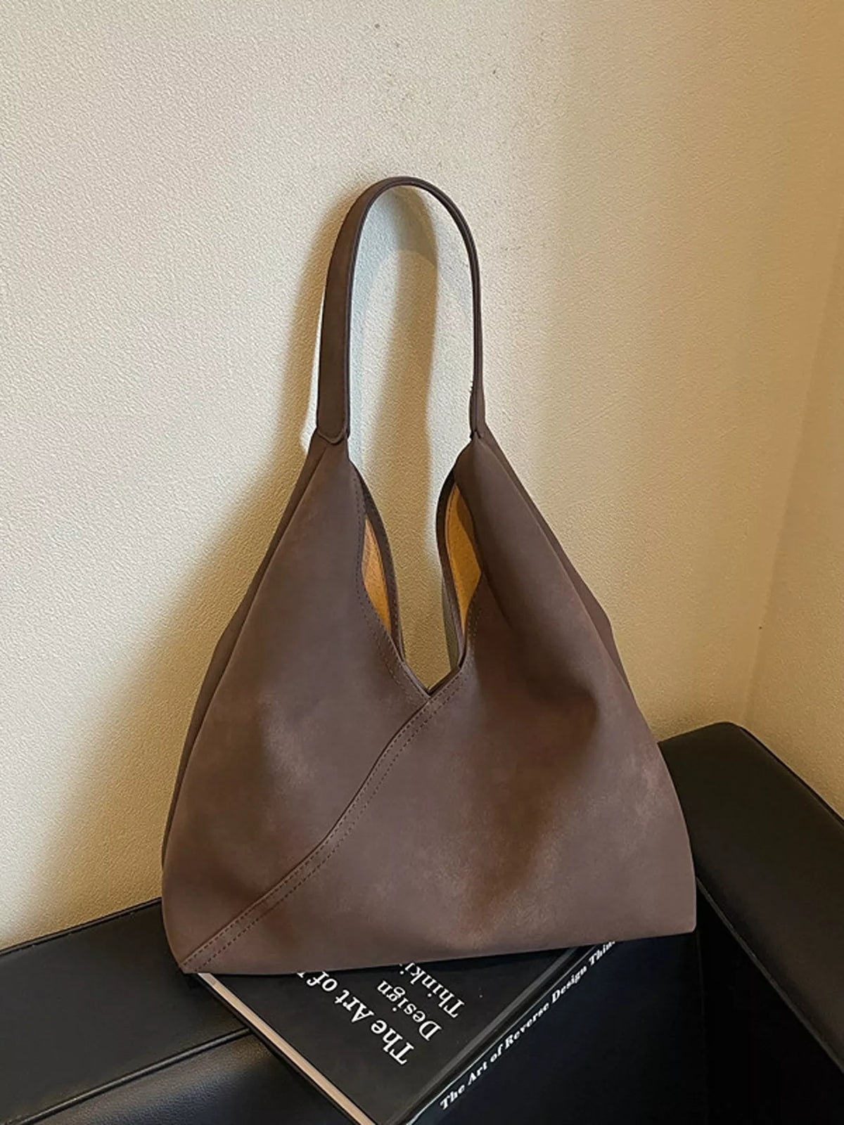 Brown slouchy suede shoulder bag with open top and two top handles