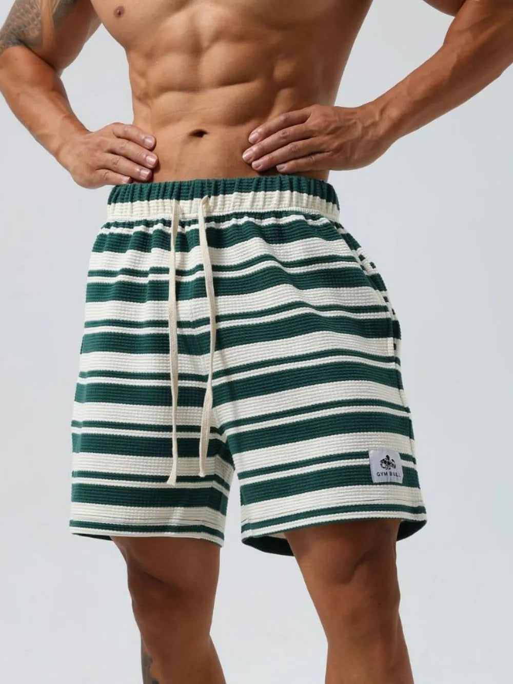 Striped drawstring shorts in dark green and white, elastic waistband, front pockets