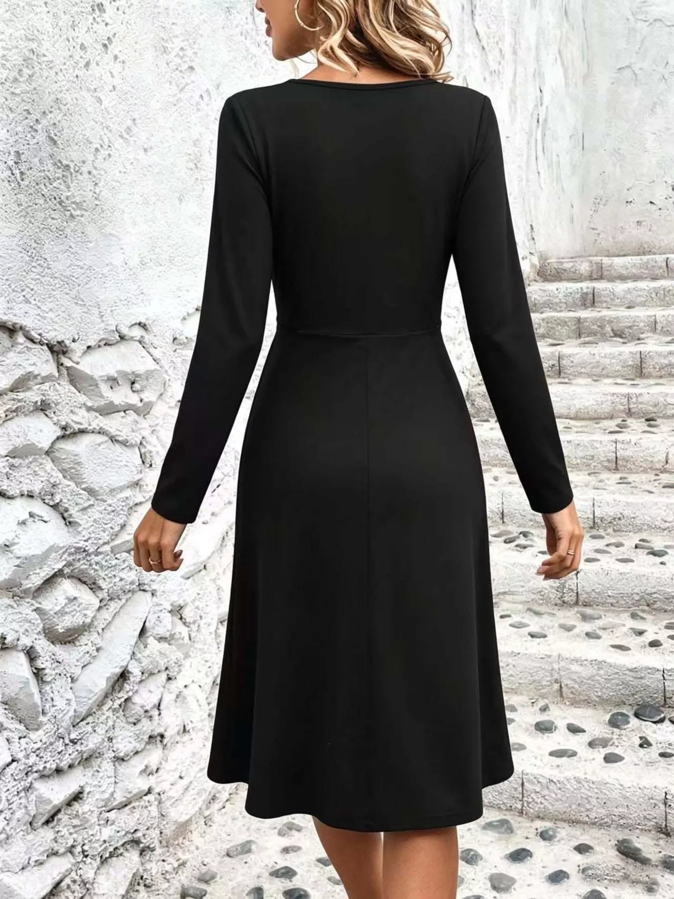 Back view: black long-sleeve midi dress with smooth back and flared skirt