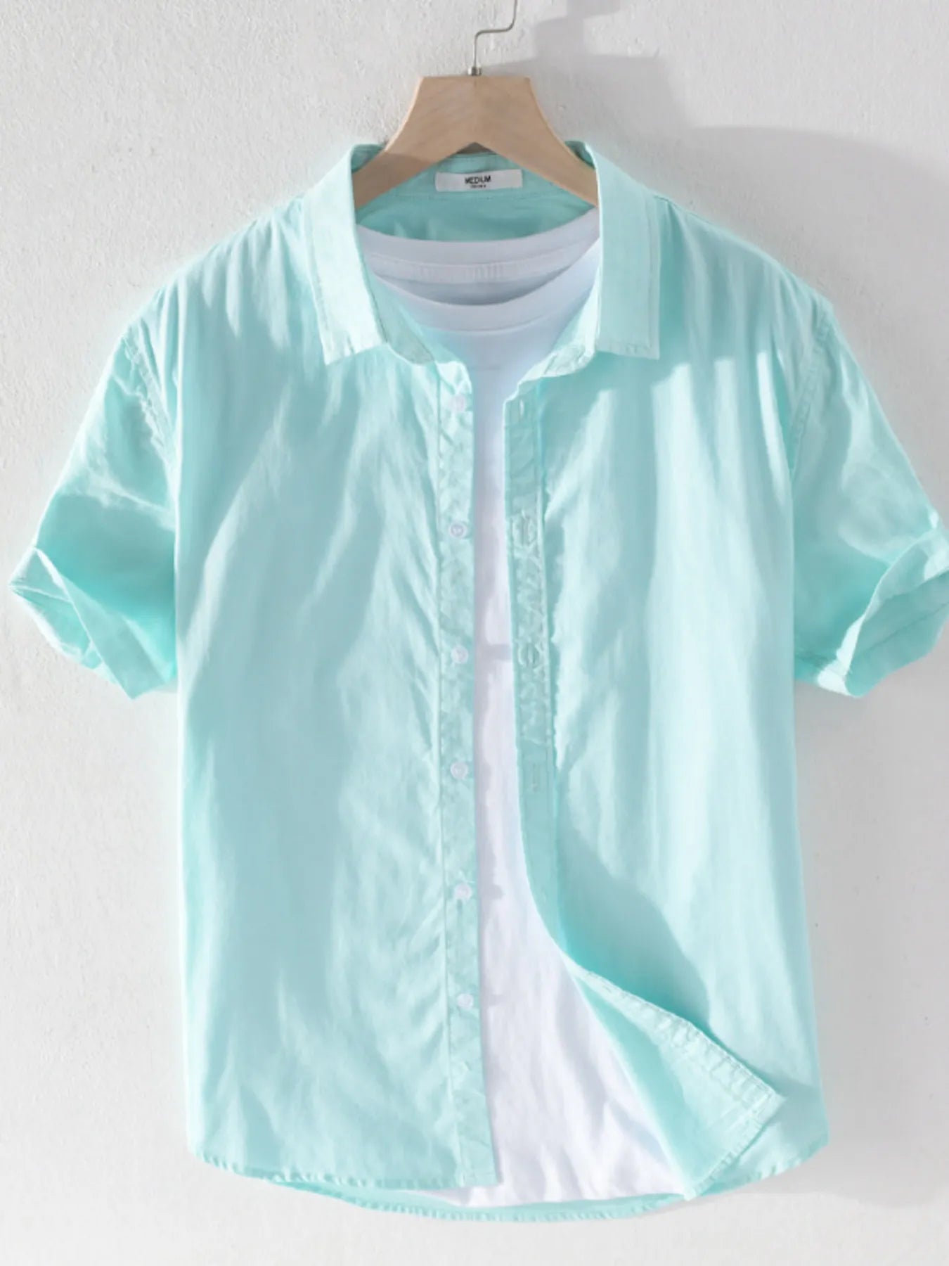 Men's short sleeve button-up shirt, light teal with front buttons and collar