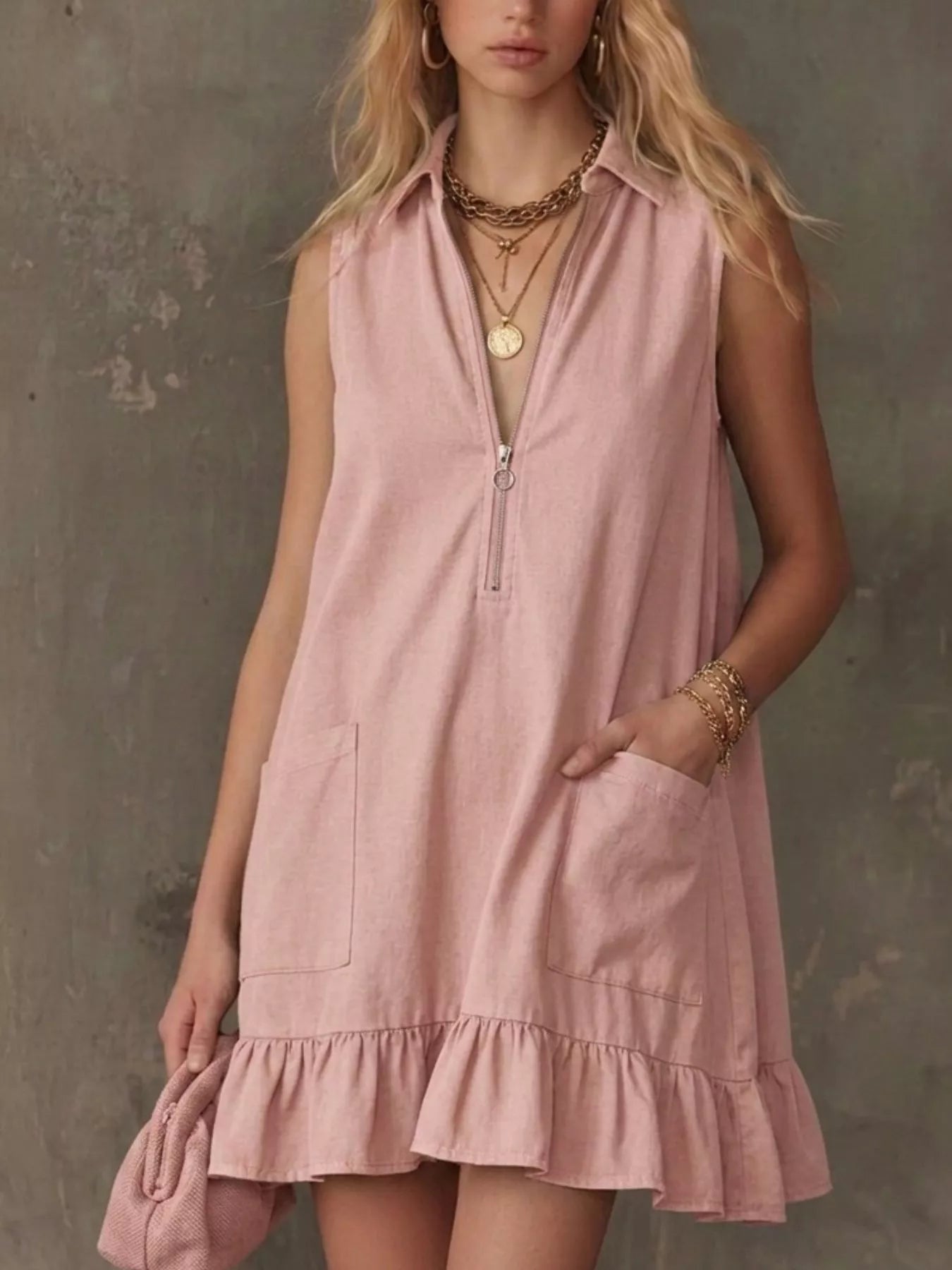 Blush pink sleeveless collared zip-front ruffle hem dress with front zip and pockets