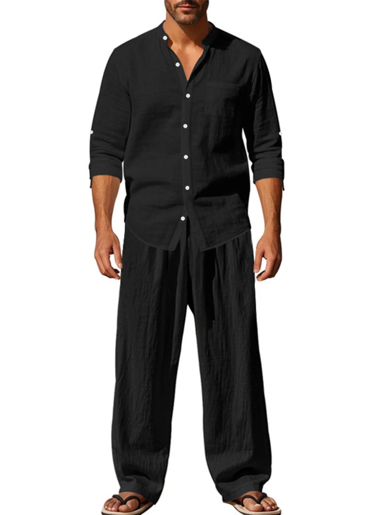 Black button-up shirt and pants set with long sleeves, collar, and front buttons