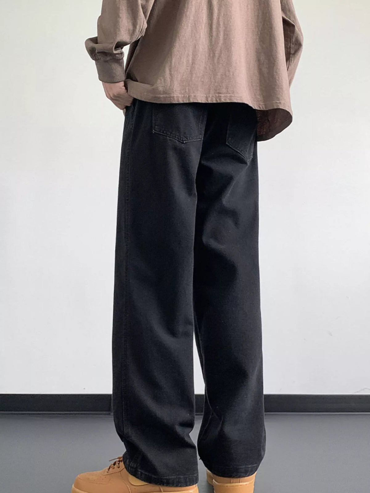 Black washed denim jeans with loose fit, wide legs, and deep front pocket details