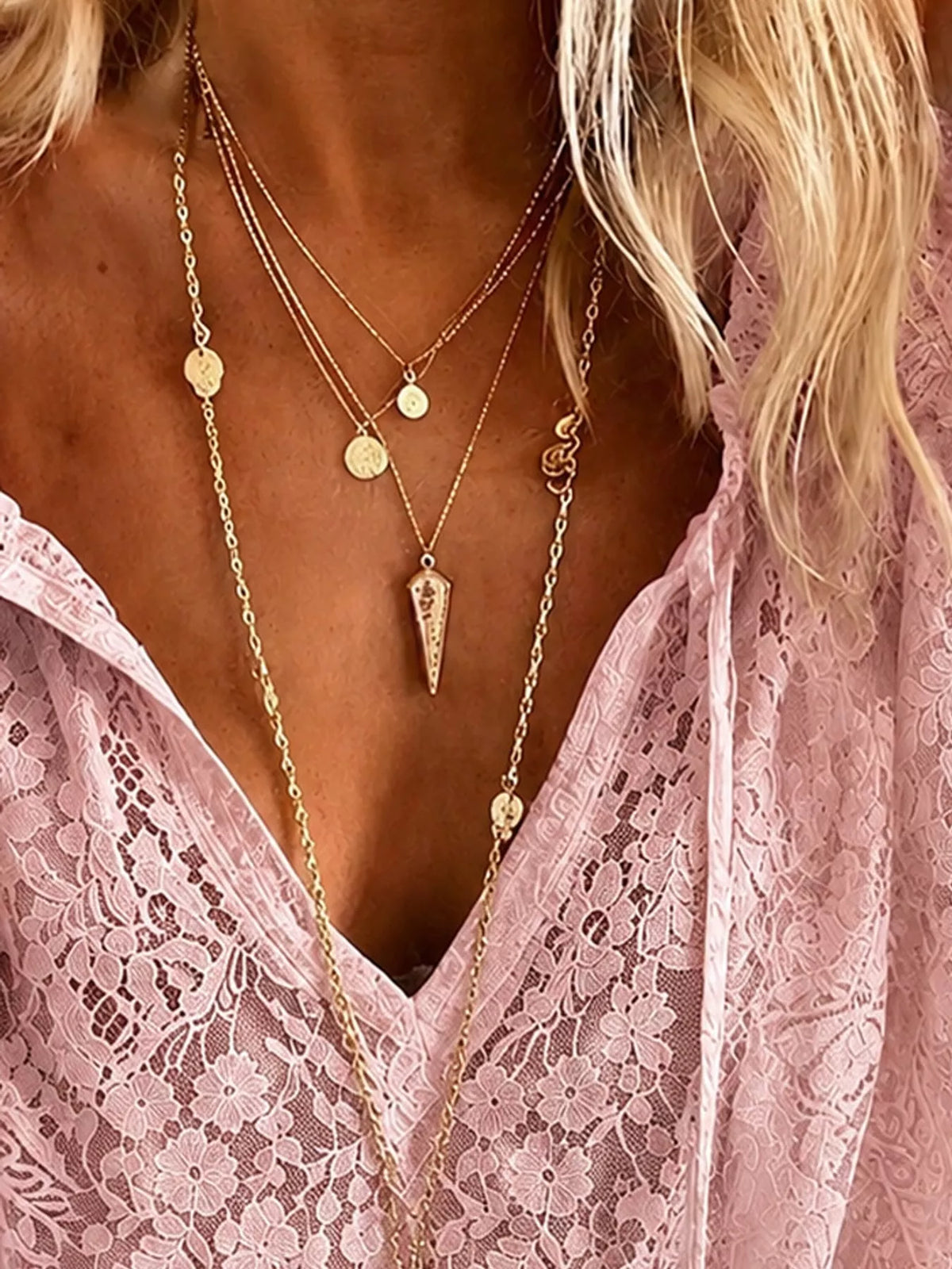 Pink openwork lace long-sleeve blouse with V-neck lace texture close-up