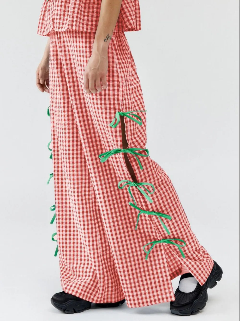Red gingham plaid pants with green side ties and wide-leg cut