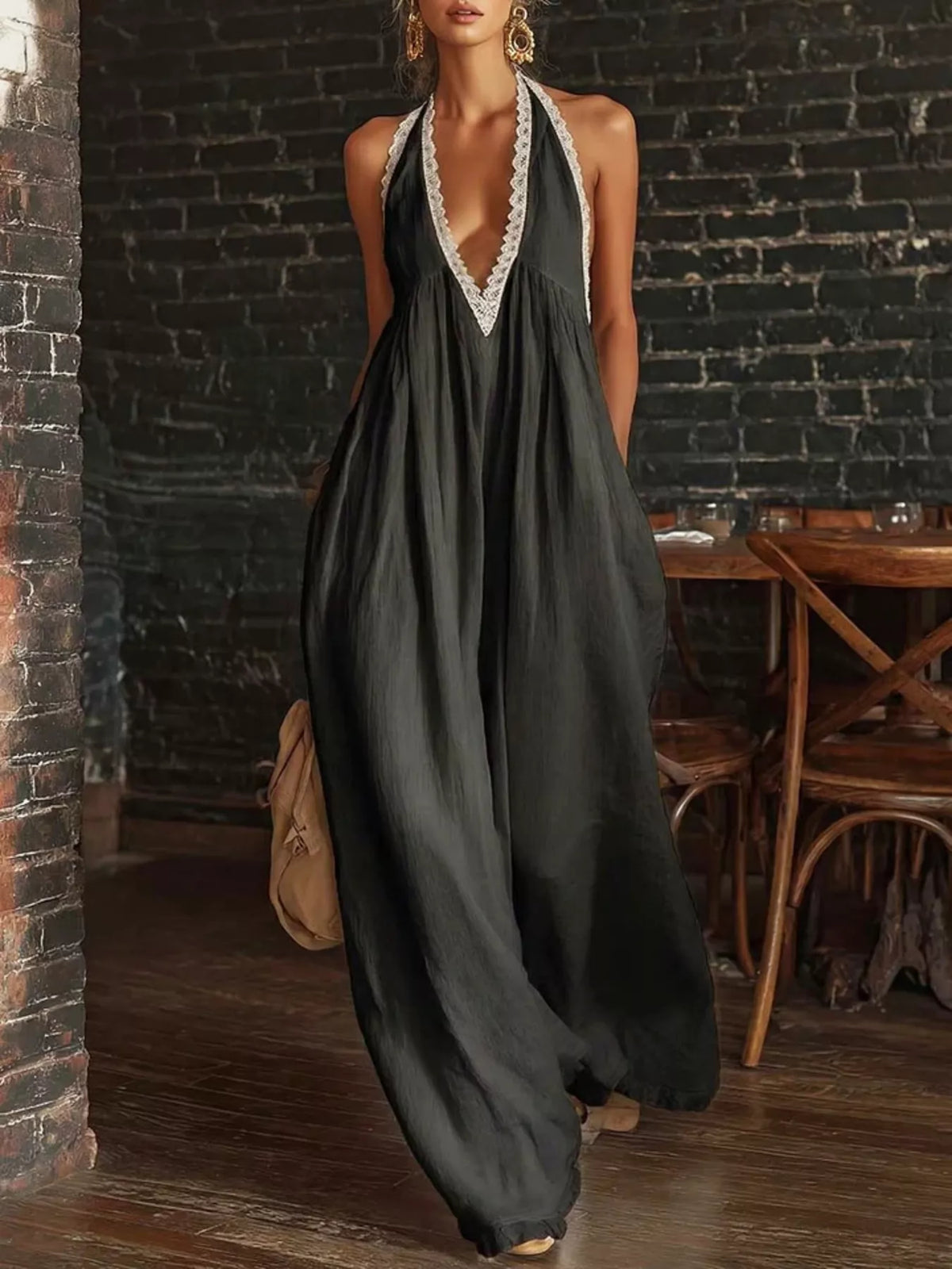 Black halter neck lace-trim wide-leg jumpsuit with deep V neckline and flowing legs