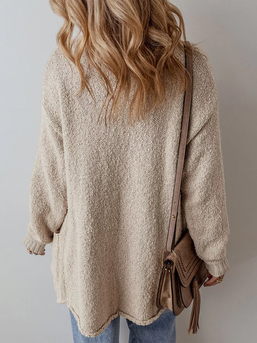 Beige knit cardigan with button placket, stand collar, long sleeves and pocket detail