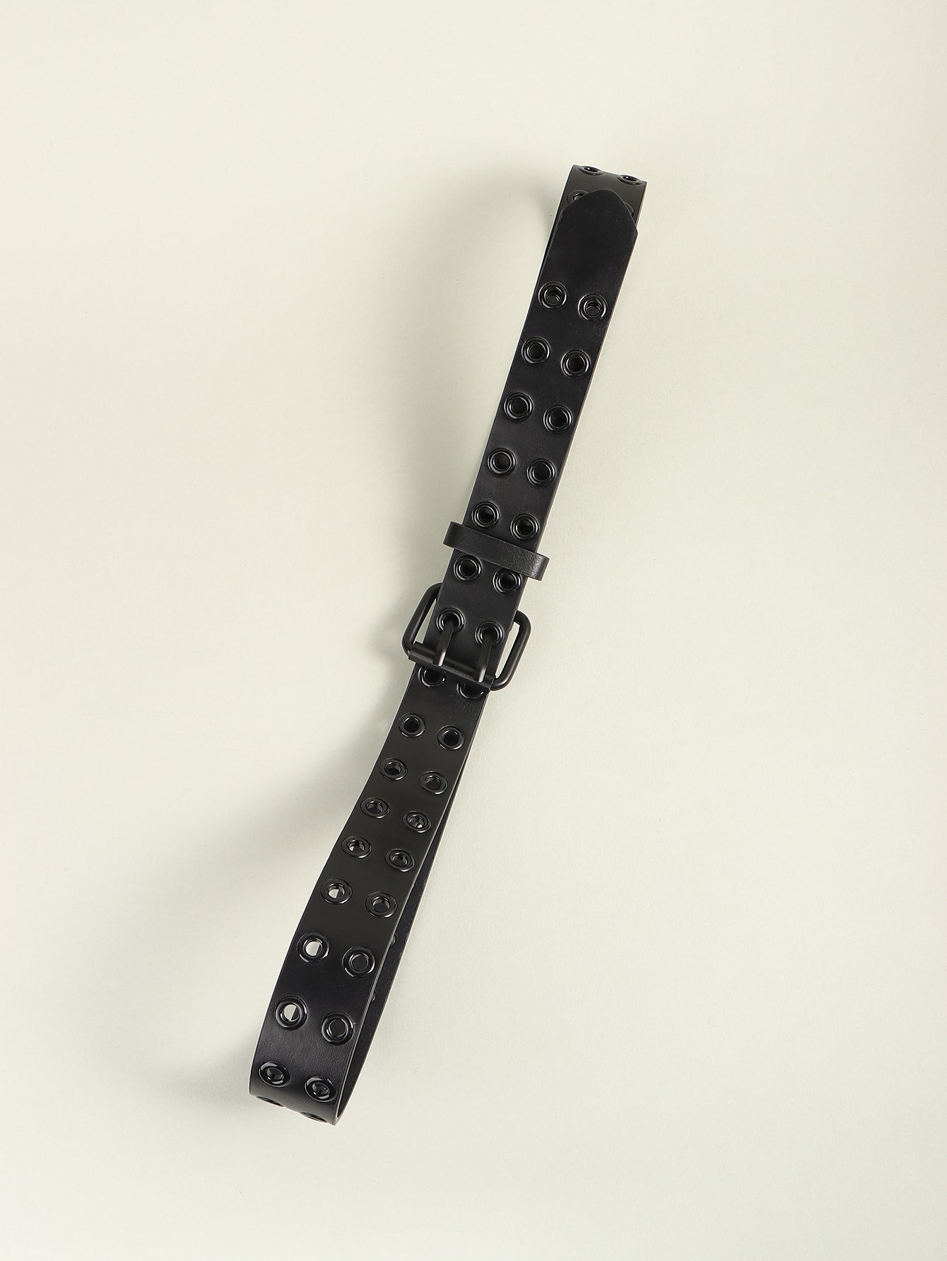 Black vegan leather grommet belt strap detail with square buckle and eyelets
