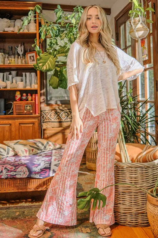 Orange patterned bell-bottom flare pants with wide leg and elastic waist