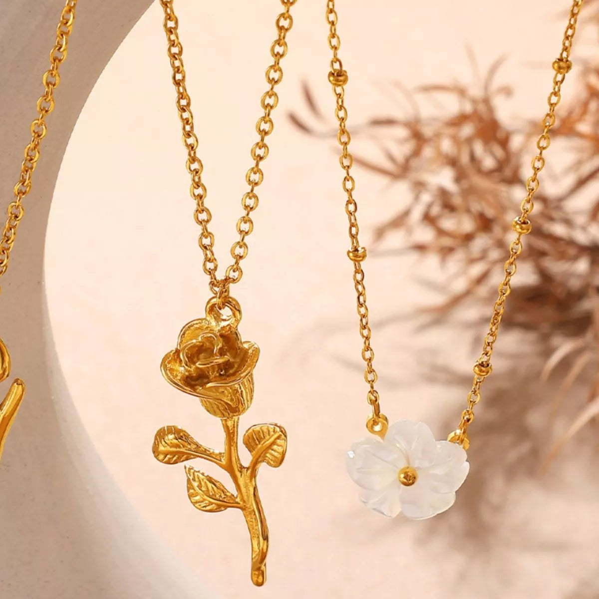 Gold-tone chain necklace with small rose and white flower pendants