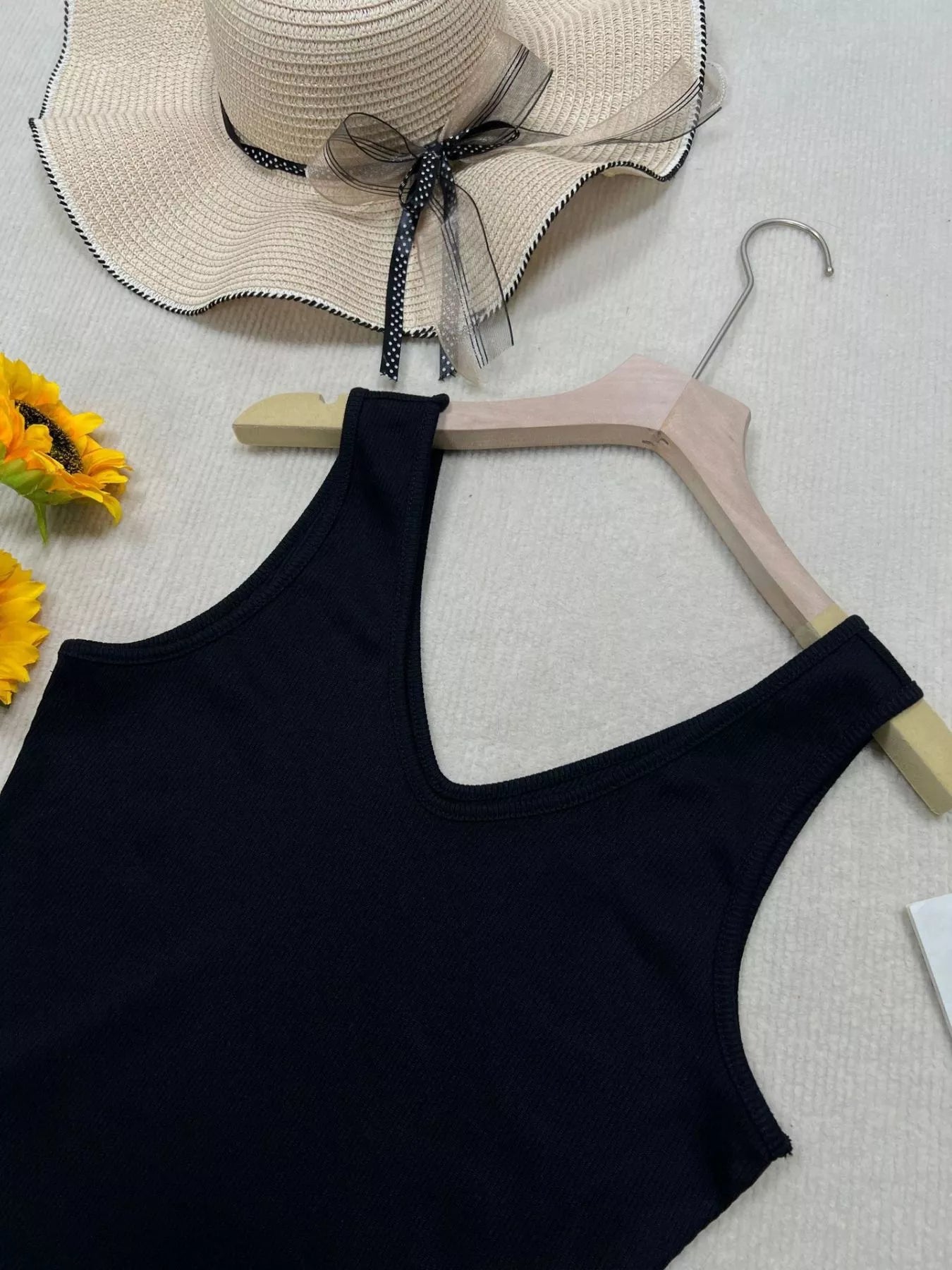 Cedar & Moore V-Neck Slim Fit Tank, black knit on hanger; beige hat and sunflowers, 3 items.