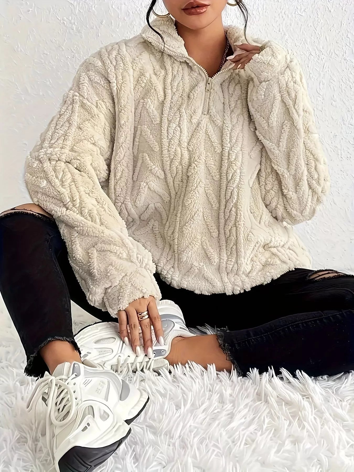 Sherpa quarter-zip sweatshirt, off-white cable knit texture, front quarter view