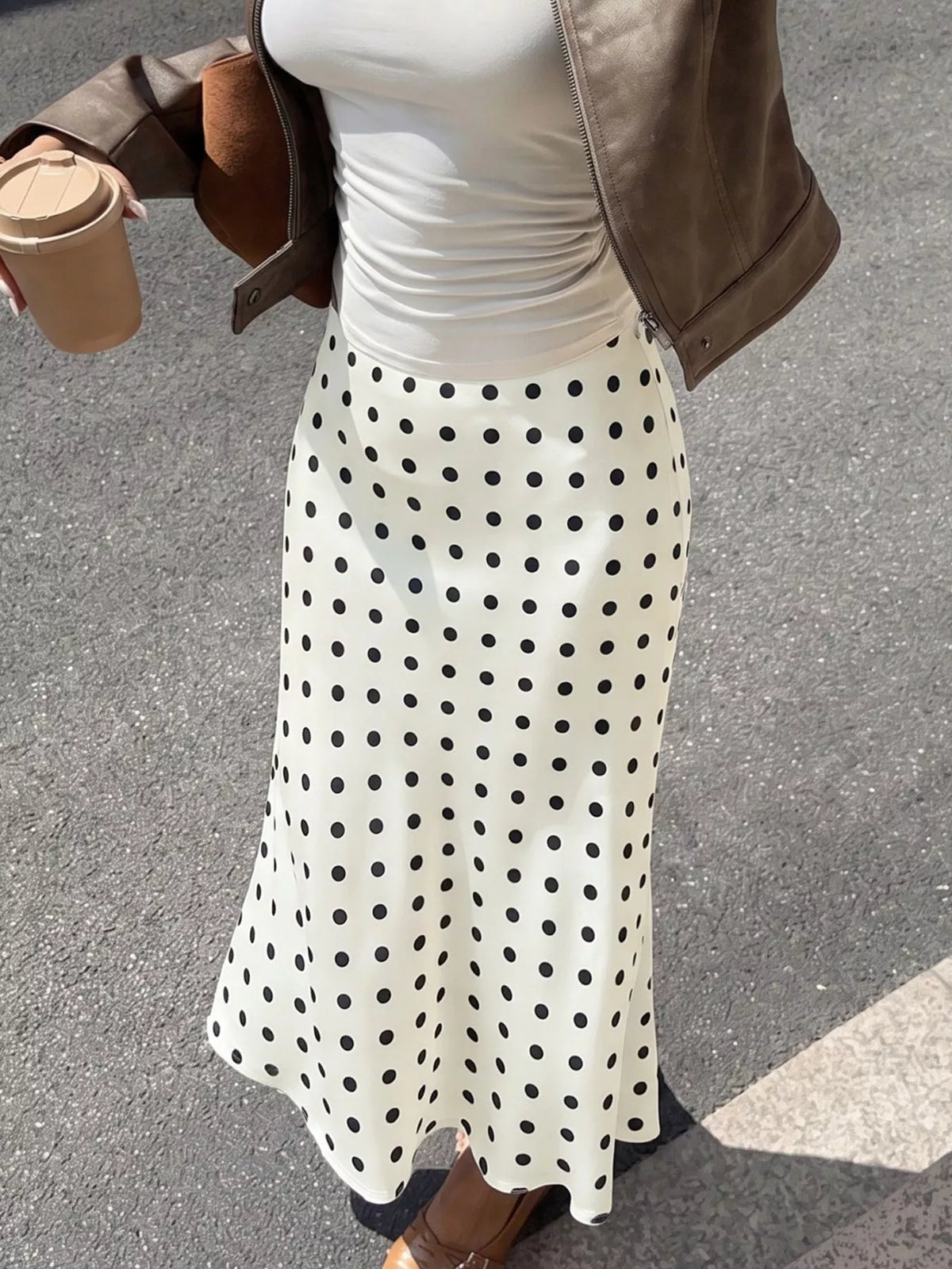 Beige polka dot stretch midi skirt, close-up of waistband and skirt texture
