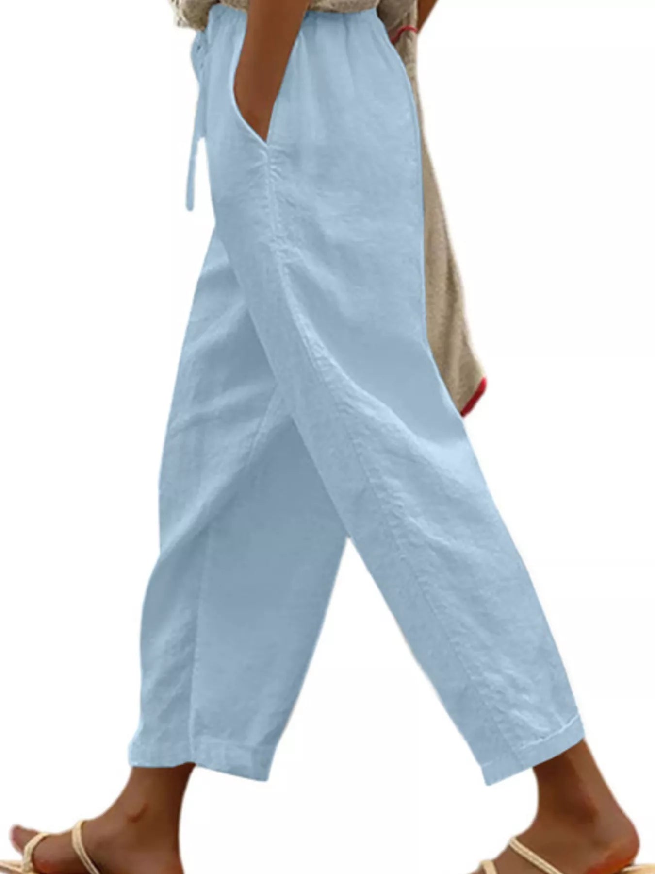 Light blue cropped drawstring pants with side pockets, relaxed wide-leg fit