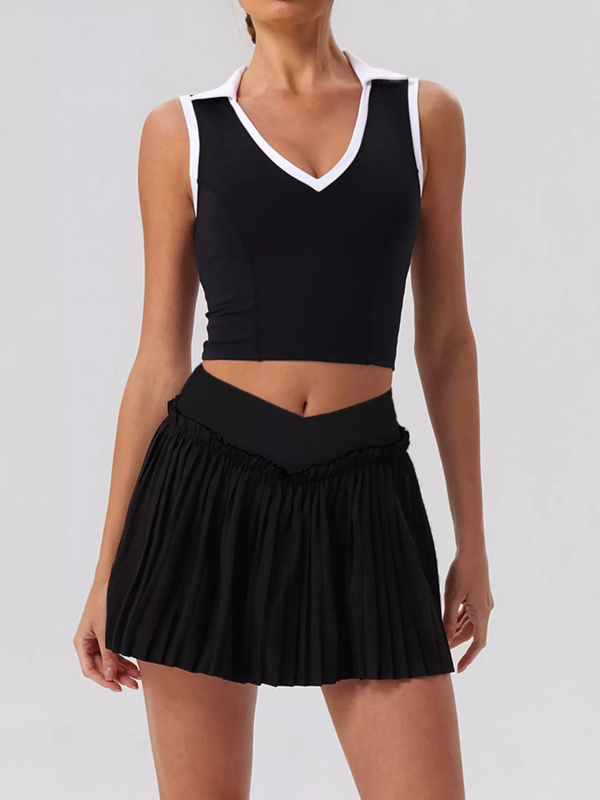 Black sleeveless V-neck crop top with elastic waist pleated mini skirt set