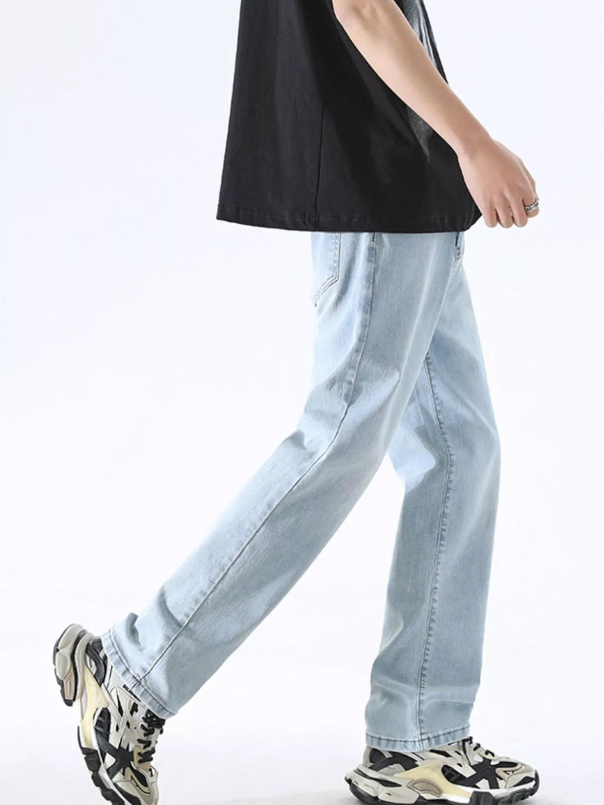 Light blue wide-leg jeans with belt loops and straight relaxed legs, side view.