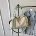 Large polyester duffle bag in beige with green contrast handles and shoulder strap