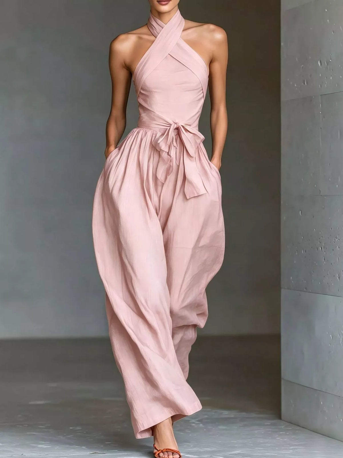 Blush pink halter neck wide-leg jumpsuit with waist tie and gathered skirt