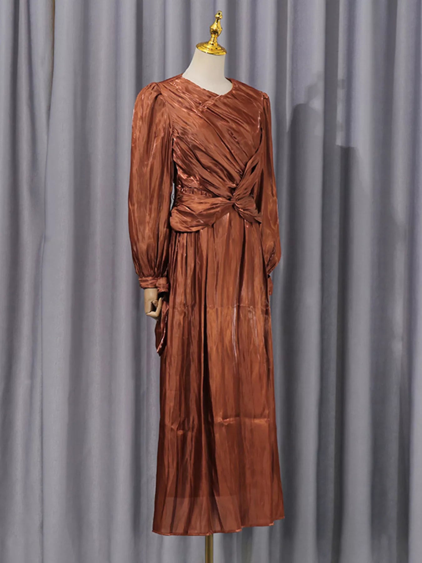 Cedar & Moore Front Twisted Draped Long Sleeve Maxi Dress in copper-burnt orange satin with ruched waist.