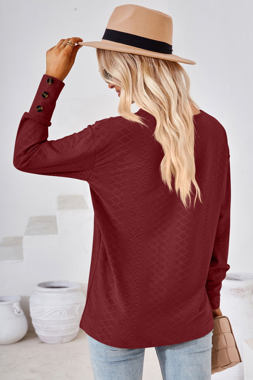 Burgundy V-neck long-sleeve blouse back view with textured diamond pattern
